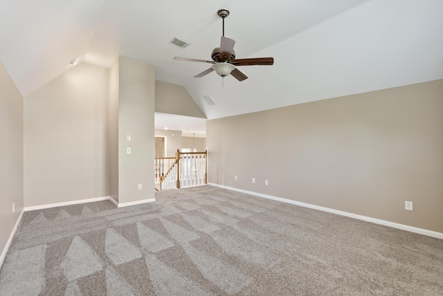 unfurnished living room featuring ceiling fan with notable chandelier, carpet floors, and lofted ceiling