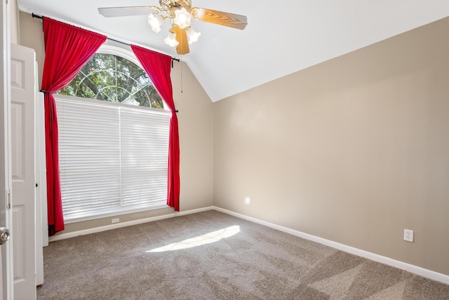 empty room with ceiling fan, lofted ceiling, and carpet floors