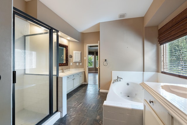 bathroom featuring vanity and shower with separate bathtub