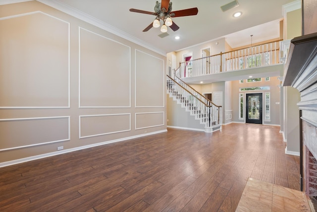 unfurnished living room with hardwood / wood-style floors, ceiling fan, and crown molding