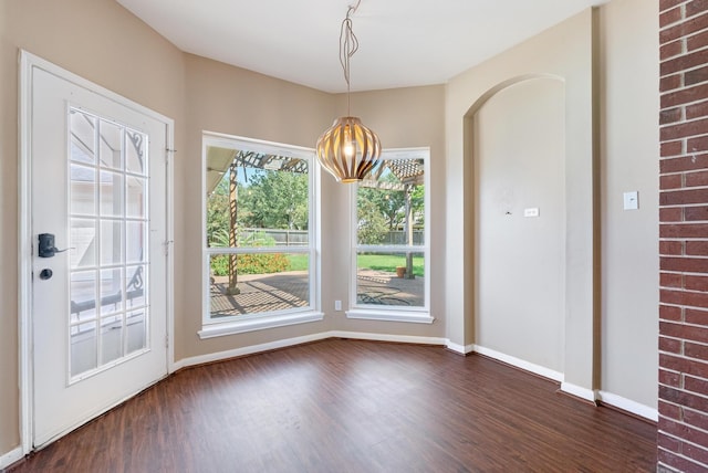 unfurnished dining area featuring dark hardwood / wood-style flooring