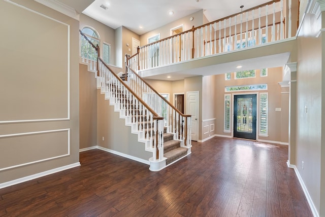 entrance foyer featuring hardwood / wood-style flooring and a high ceiling