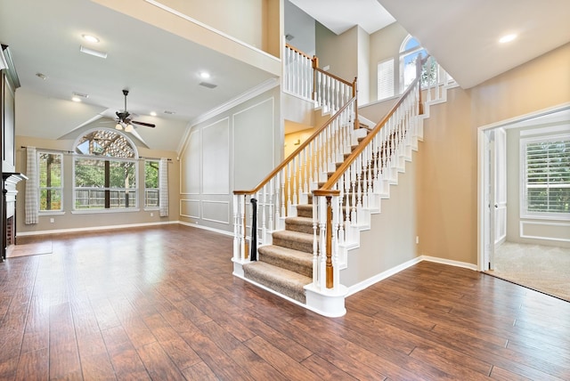 unfurnished living room featuring dark hardwood / wood-style floors, vaulted ceiling, and plenty of natural light