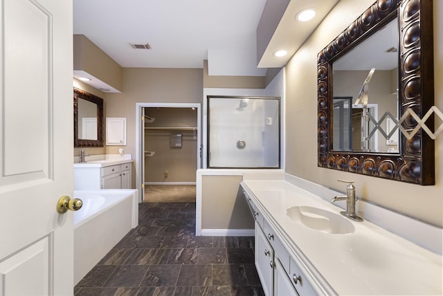 bathroom with vanity and separate shower and tub