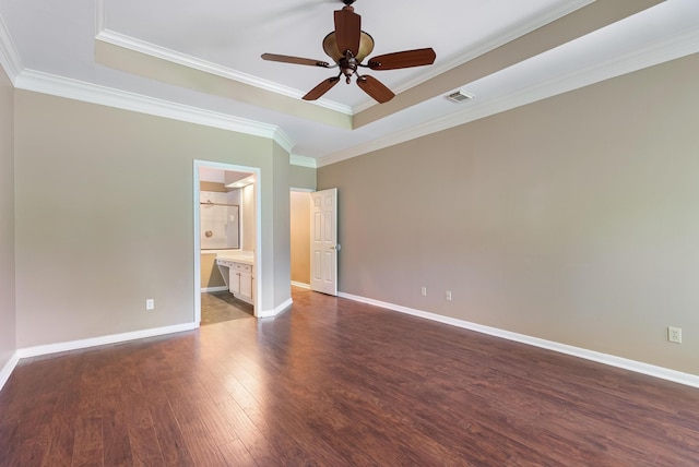 unfurnished bedroom featuring connected bathroom, dark wood-type flooring, ceiling fan, and crown molding