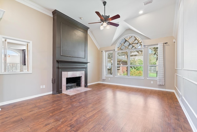 unfurnished living room featuring wood-type flooring, ceiling fan, lofted ceiling, and a tiled fireplace