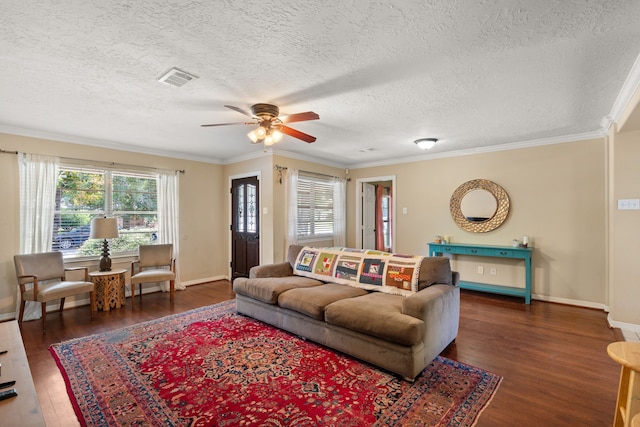 living room featuring dark hardwood / wood-style floors, ceiling fan, ornamental molding, and a textured ceiling