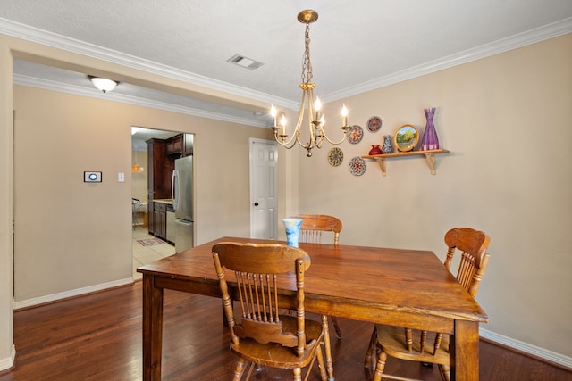 dining area featuring crown molding, wood-type flooring, and an inviting chandelier