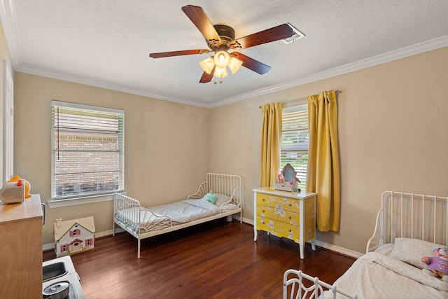 bedroom featuring multiple windows, ceiling fan, dark hardwood / wood-style flooring, and ornamental molding