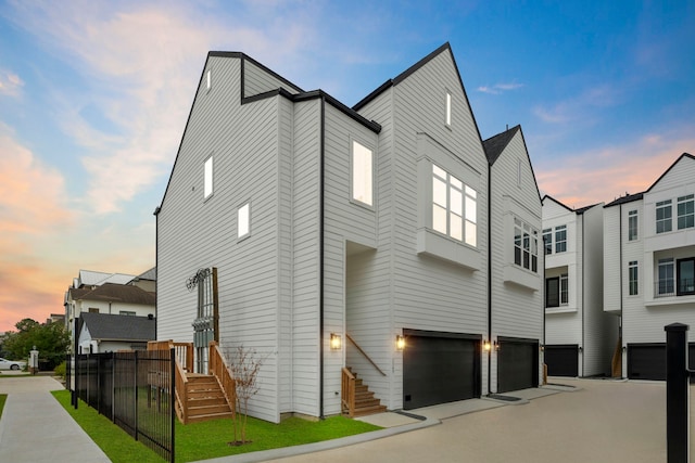 property exterior at dusk featuring a garage