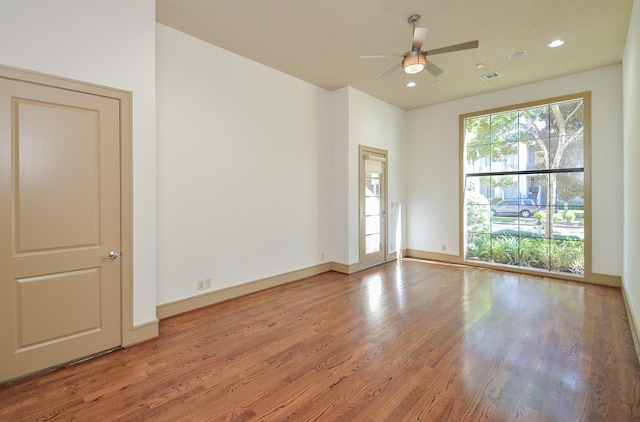 empty room with hardwood / wood-style flooring and ceiling fan