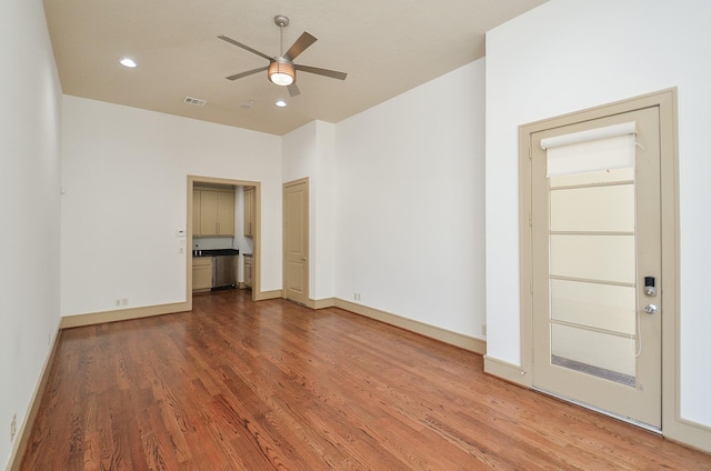 empty room featuring hardwood / wood-style floors and ceiling fan