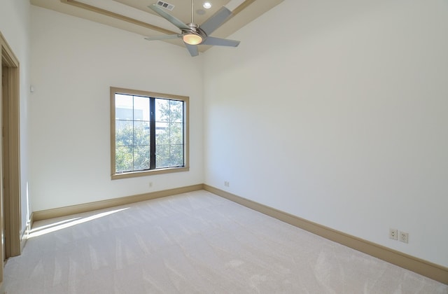 spare room featuring ceiling fan and light carpet