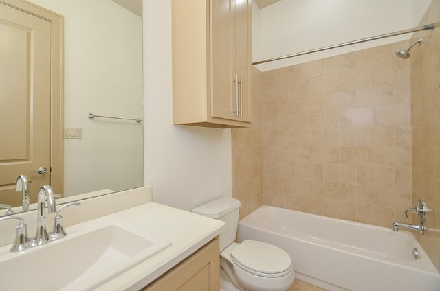 full bathroom featuring vanity, toilet, and tiled shower / bath