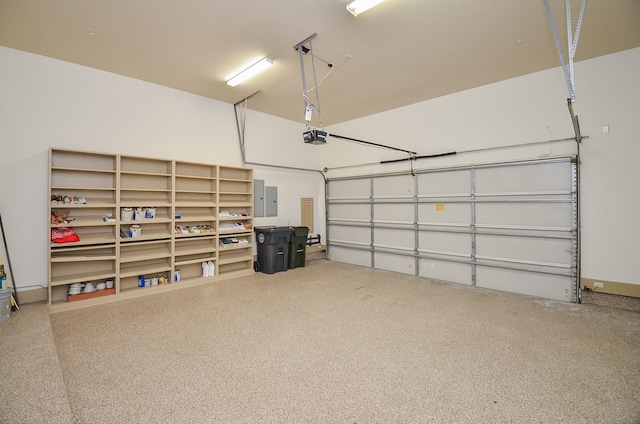 garage featuring electric panel and a garage door opener