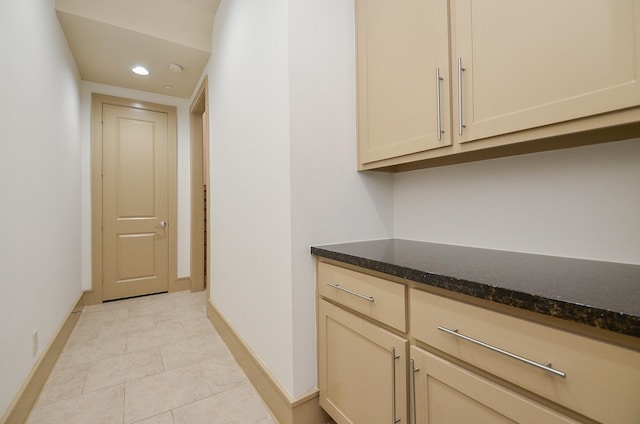 corridor featuring light tile patterned floors