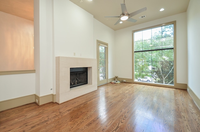 unfurnished living room with ceiling fan and hardwood / wood-style floors