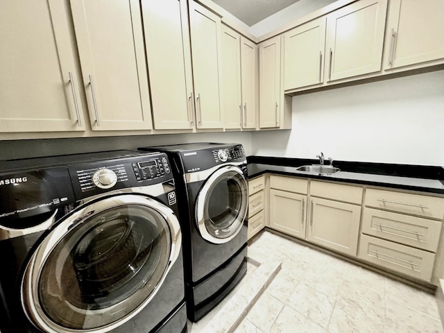 laundry room featuring cabinets, sink, and washer and dryer