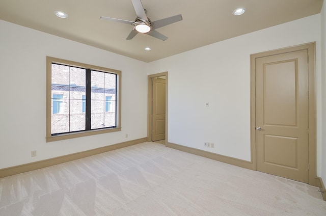 carpeted empty room featuring ceiling fan