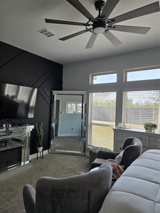 living room featuring carpet flooring and ceiling fan