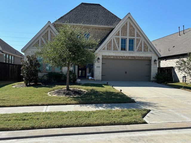 view of front of home featuring a front yard and a garage