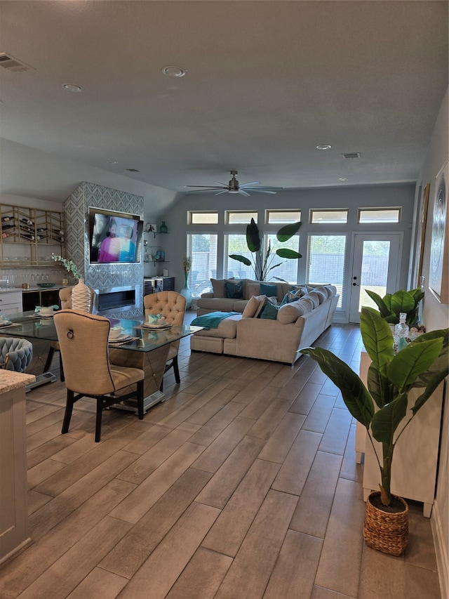 living room with ceiling fan and light wood-type flooring