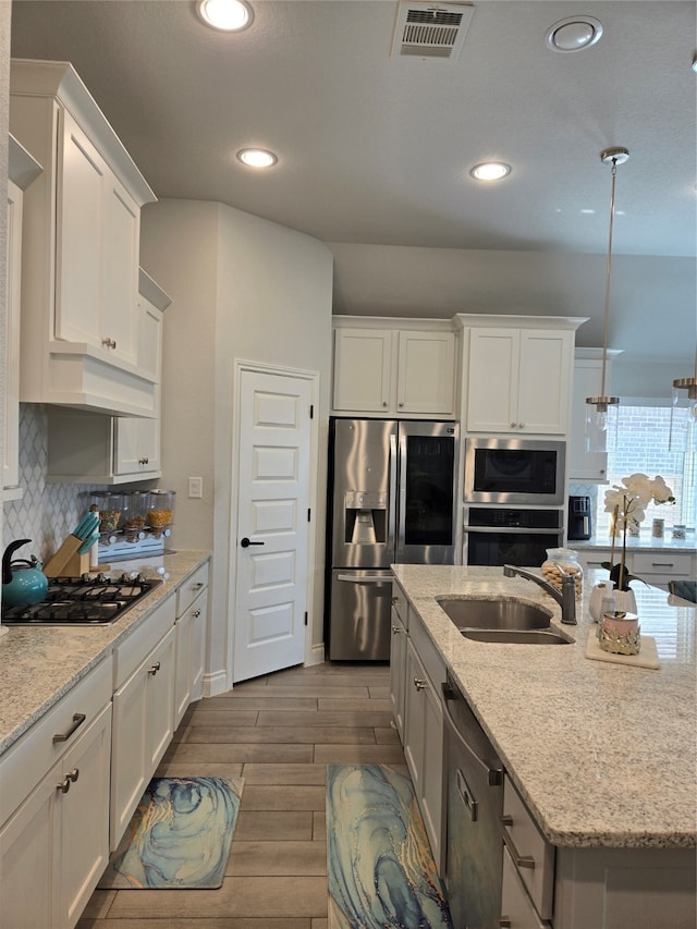 kitchen featuring white cabinetry, sink, and appliances with stainless steel finishes