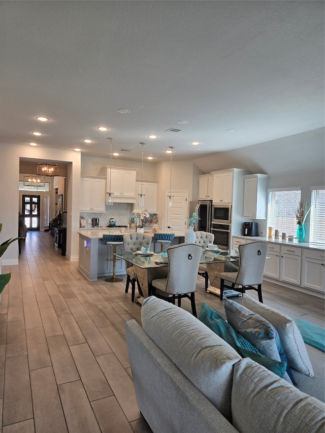 living room featuring light hardwood / wood-style flooring and a chandelier