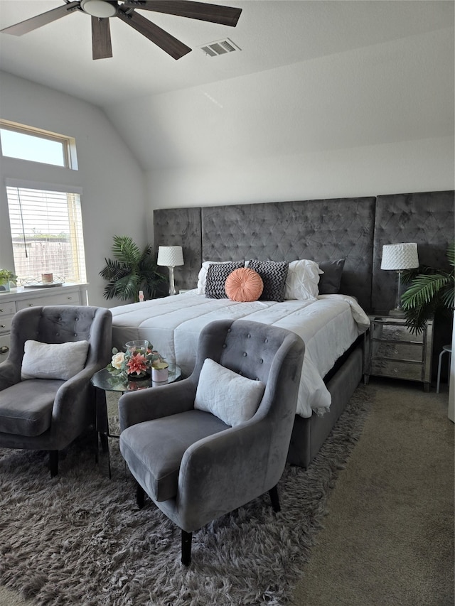 carpeted bedroom with ceiling fan and vaulted ceiling