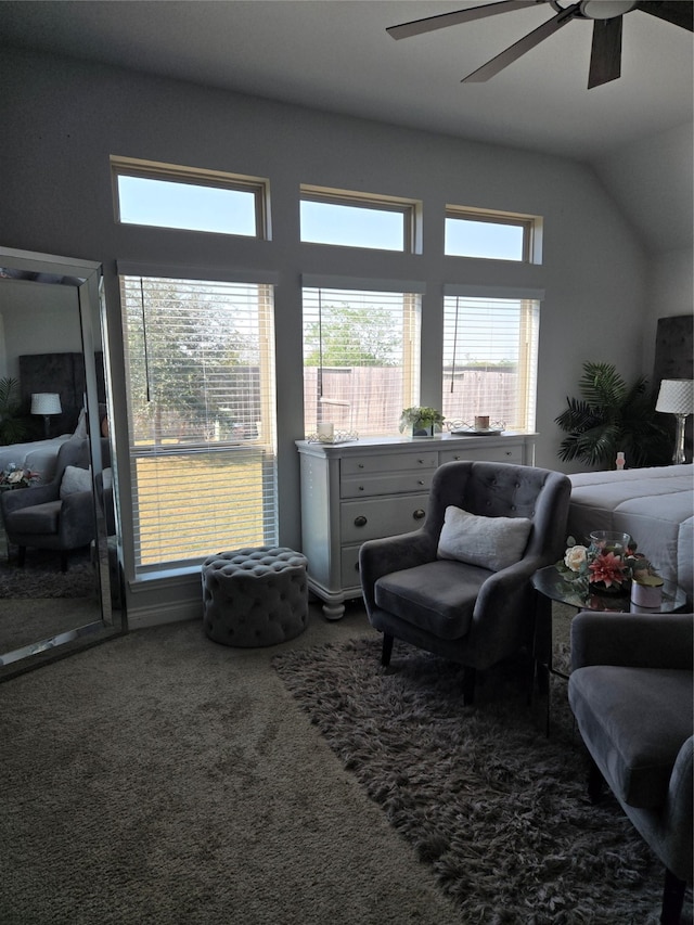 living room featuring ceiling fan, carpet floors, and vaulted ceiling