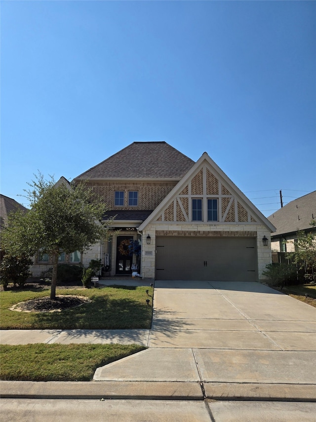 view of front of house with a garage and a front yard