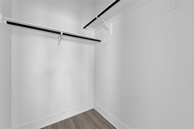 walk in closet with wood-type flooring