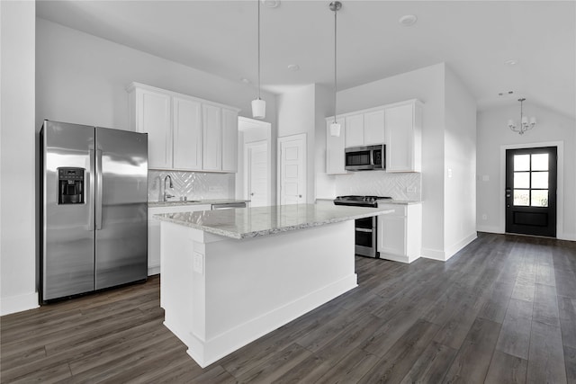 kitchen featuring white cabinetry, a kitchen island, pendant lighting, and appliances with stainless steel finishes