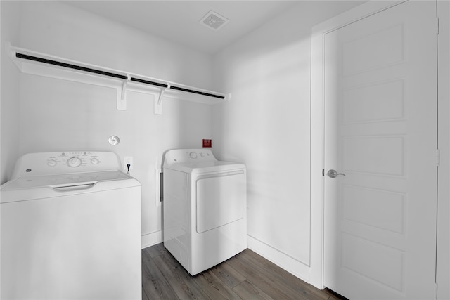 washroom featuring separate washer and dryer and dark wood-type flooring