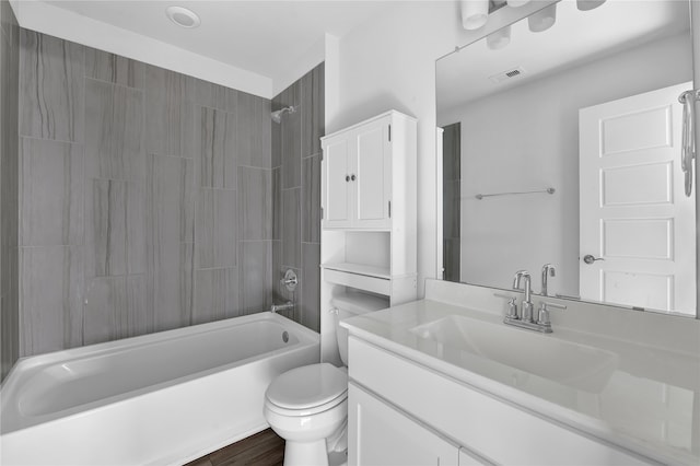 full bathroom with toilet, vanity, hardwood / wood-style floors, and tiled shower / bath