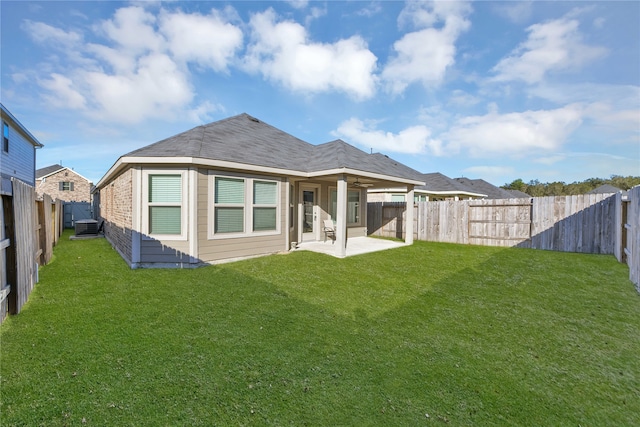 rear view of property with a lawn, central AC, and a patio