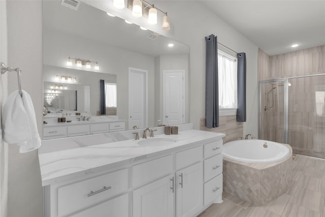 bathroom with shower with separate bathtub and vanity