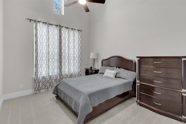 bedroom with ceiling fan and light carpet