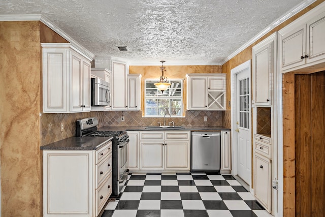 kitchen featuring tasteful backsplash, stainless steel appliances, crown molding, sink, and decorative light fixtures