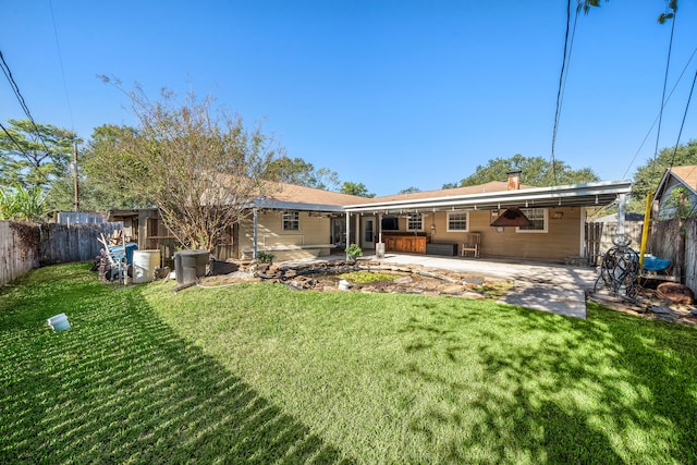 back of property featuring ceiling fan, a patio area, and a lawn