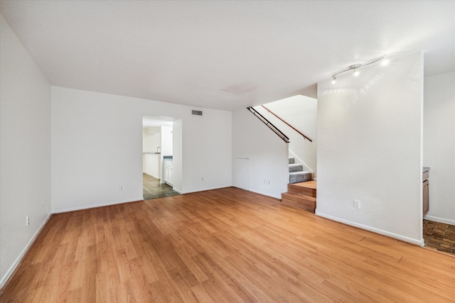 unfurnished living room with wood-type flooring