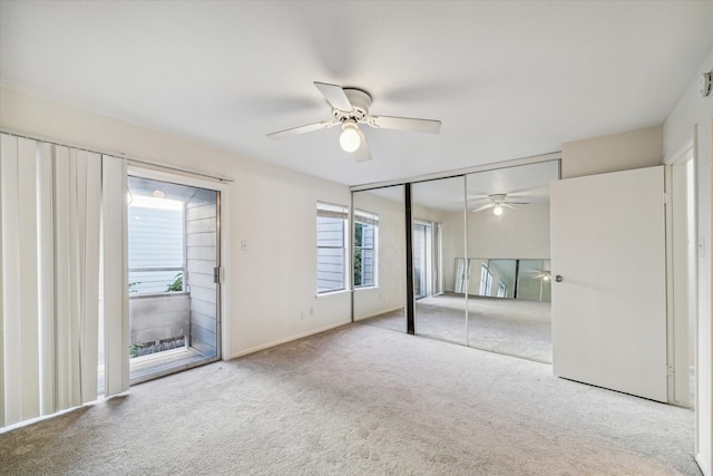 unfurnished bedroom featuring ceiling fan, a closet, and light carpet