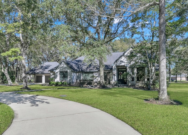 view of front of property with a garage and a front yard