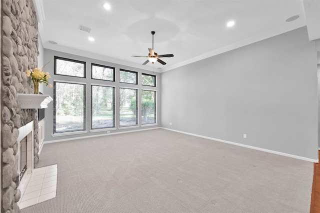 unfurnished living room with crown molding, a fireplace, carpet, and plenty of natural light