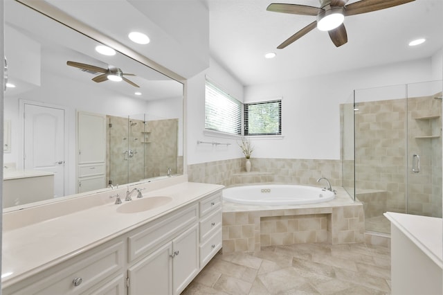 bathroom with plus walk in shower, vanity, and ceiling fan