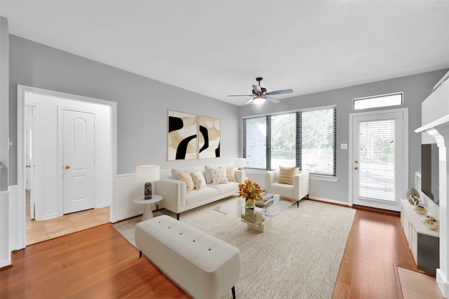 living room featuring ceiling fan and hardwood / wood-style floors