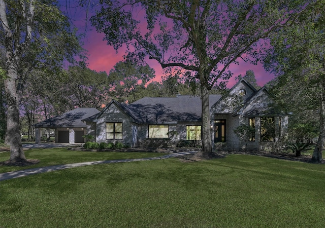 view of front of property featuring a yard and a garage