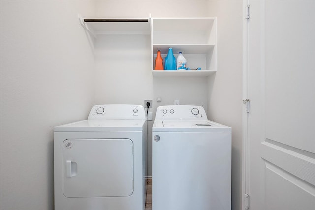 laundry area featuring hardwood / wood-style flooring and washing machine and dryer