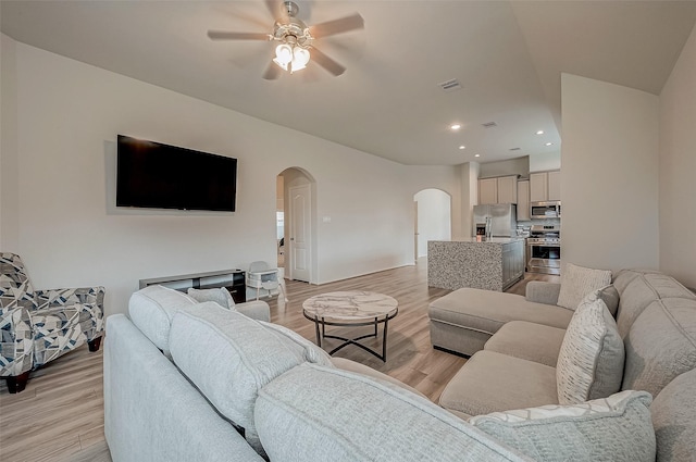 living room featuring light hardwood / wood-style floors and ceiling fan