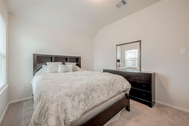 carpeted bedroom featuring vaulted ceiling